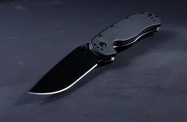 Photo knife at an angle. Folding knife at an angle.