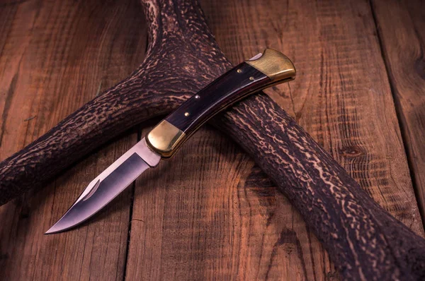 Premium knife. Legendary hunting knife. Hunting knife and antler. Front view.