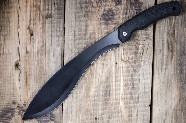 Black machete on wooden background. Machete top view. — Stock Photo, Image