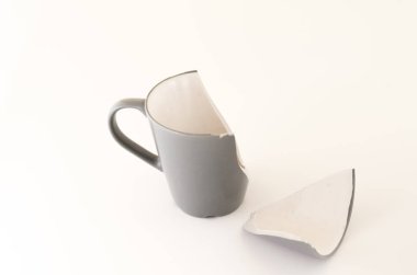 Kırık bir çay bardağı. Seramikten yapılmış gri kupa.