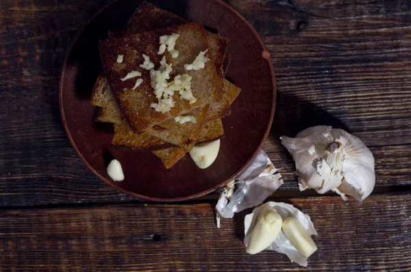 Rectangular pieces of bread and garlic. Ukrainian toast.