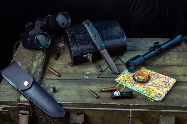 Binoculars and scope. Knife and bullets. Map and compass. — ストック写真