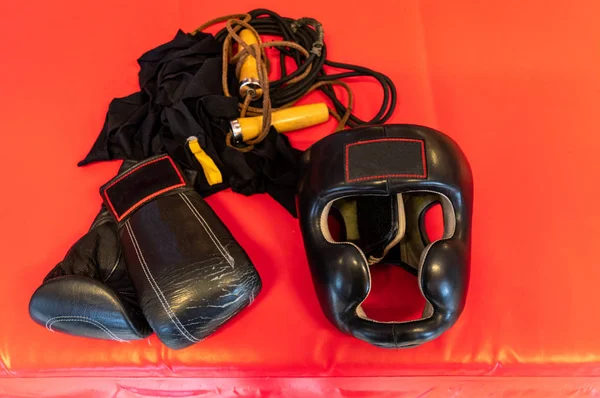 Boxing helmet and gloves. Boxing bandages and a jump rope.