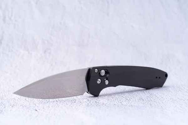 Elegant folding knife with a mirror blade. Very sharp knife with a brilliant blade. Front view.