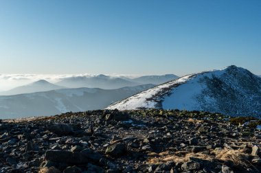 Tepeler ve dağlık arazi. Karlı dağlarda gezmek.