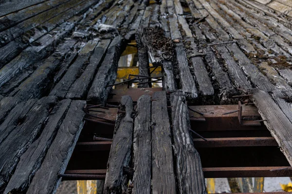 Old wooden boards. Old boards with nails. Burnt boards with nails. Leading lines from boards.