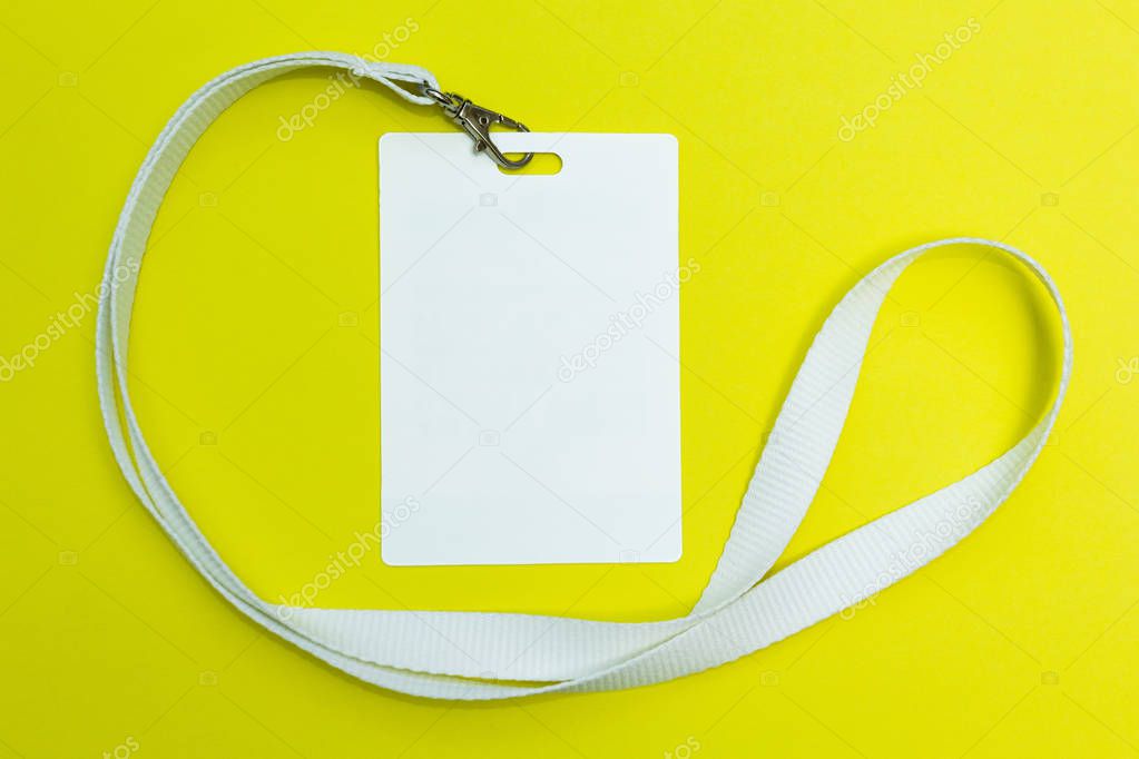 Blank badge mockup isolated on yellow. Plain empty name tag with string.