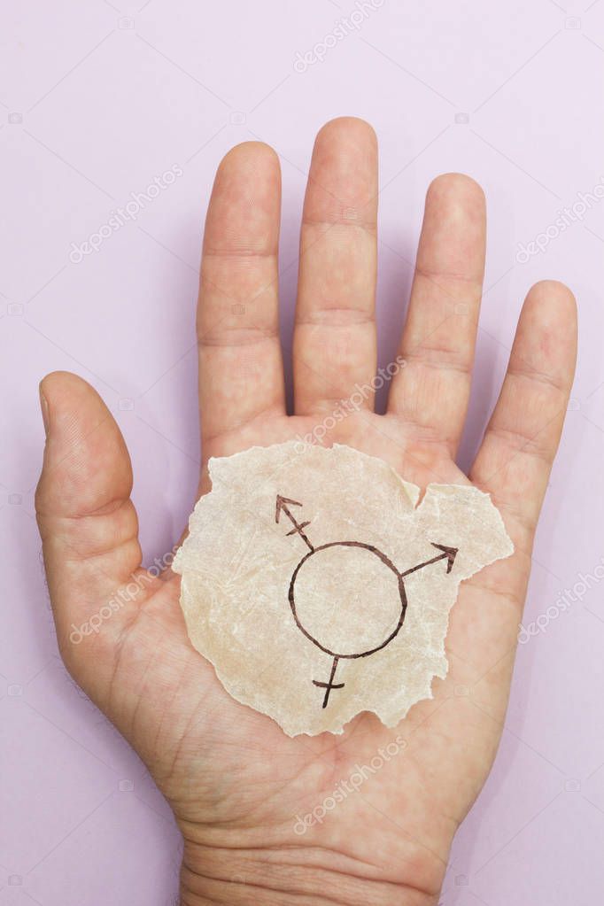 Symbol of a transgender in an open hand on a purple background. Vertically.