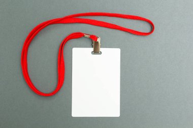Empty layout layout isolated on black. A common blank label name tag hanging on the neck with a red thread on a gray background. clipart
