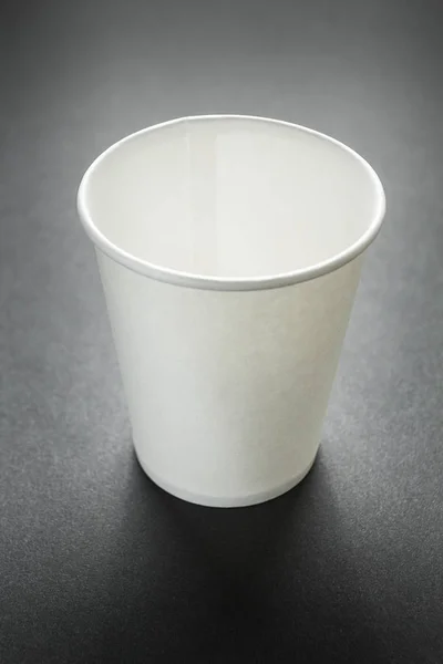 Empty takeaway cup of coffee, tea or juice on black, mockup. Ver — Stock Photo, Image