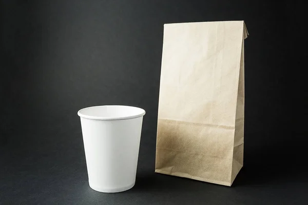 Tasses en papier blanc et un sac d'emballage de la mise en page de papier recyclé sur — Photo