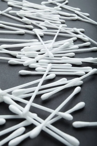 Vertical white cotton sticks on black background. — Stock Photo, Image