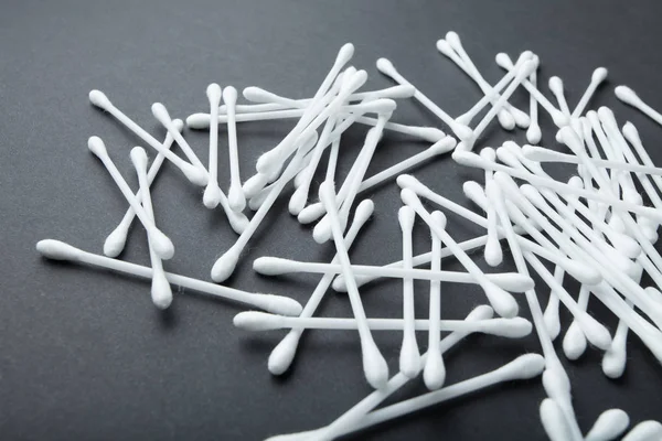 Cotton swabs on a black background.