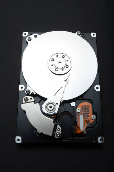 Inside the computer hard drive. Composite parts on a black backg