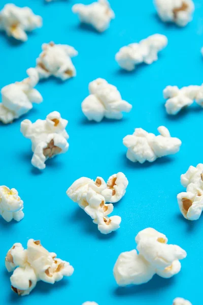 Classic popcorn on a blue background, vertical pattern.