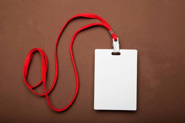 White Name Tag With red Lanyard.