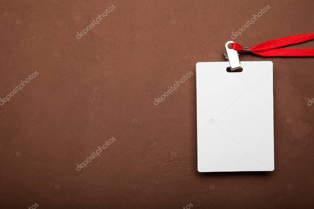 Blank badge mockup isolated on brown background.