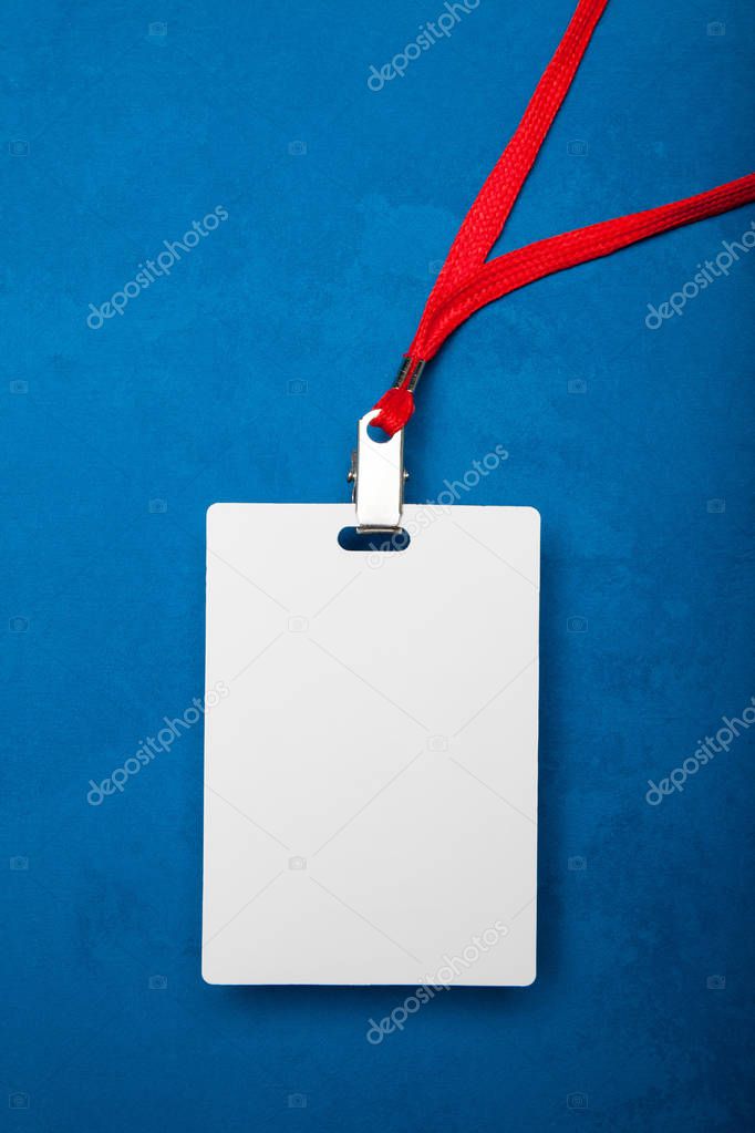Blank identification card with red neckband isolated on blue bac