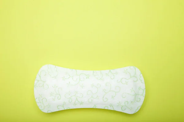 Close up, sanitary hygiene protection on green background. Empty