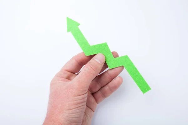 Arrow up from the chart in hand on a white background. — Stock Photo, Image