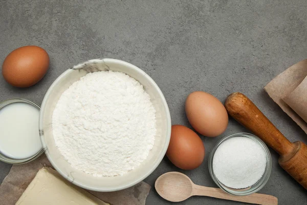 Variety of ingredients for baking on grey background. — Stock Photo, Image