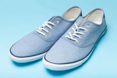 Mavi arka planda yumuşak rahat mavi spor ayakkabılar.