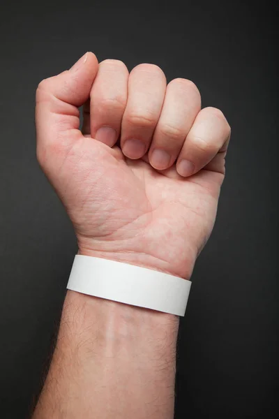 White concert paper bracelet on hand, mockup. Wristband accessor — Stock Photo, Image