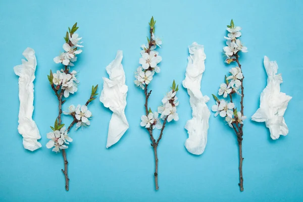 Allergy concept, white used napkins and flowers.