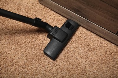 Ev temizliği, halının üzerindeki elektrikli süpürge..