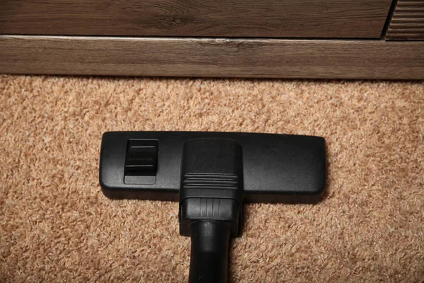 Black vacuum cleaner on dirty carpet. Housework. — Stock Photo, Image