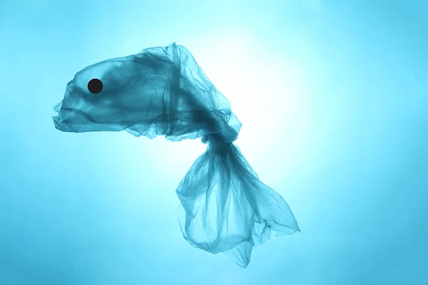 Concept ocean fish from a plastic bag. Total pollution of the ocean with garbage.