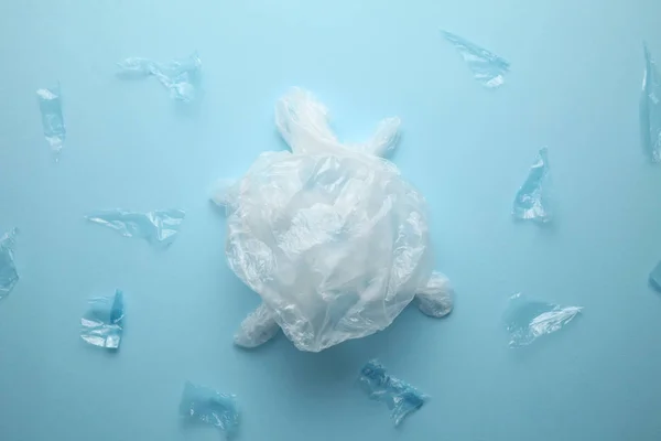 Turtle from the trash bag, the concept of pollution of nature.