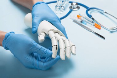 Prosthetics hands at doctor in clinic. Artificial limb. clipart