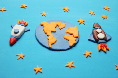 Açık uzayda, astronot rüyalarında yaratıcı el yapımı plastik roketler. Yıldızlar, Dünya gezegeni. Çizgi film sanatı.