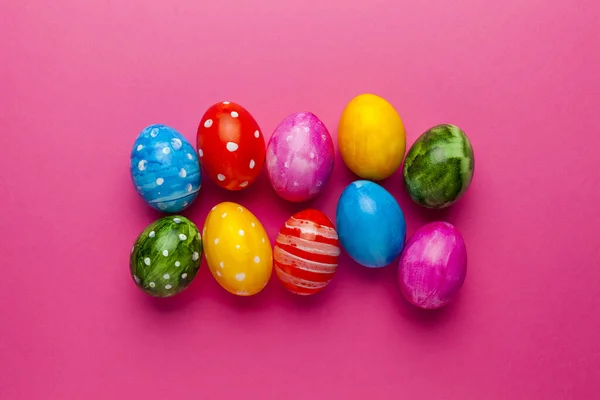 Bright easter eggs on pink background. Retro colorful spring decoration.