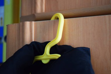 Dolapta asılı sarı askı.