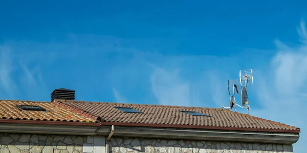 Antenna on the roof of a house.