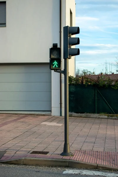 Traffic lights on a street during the day.