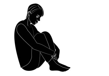 Depresyonda olan genç bir adamın silueti yerde oturmuş bacaklarını tutuyor.