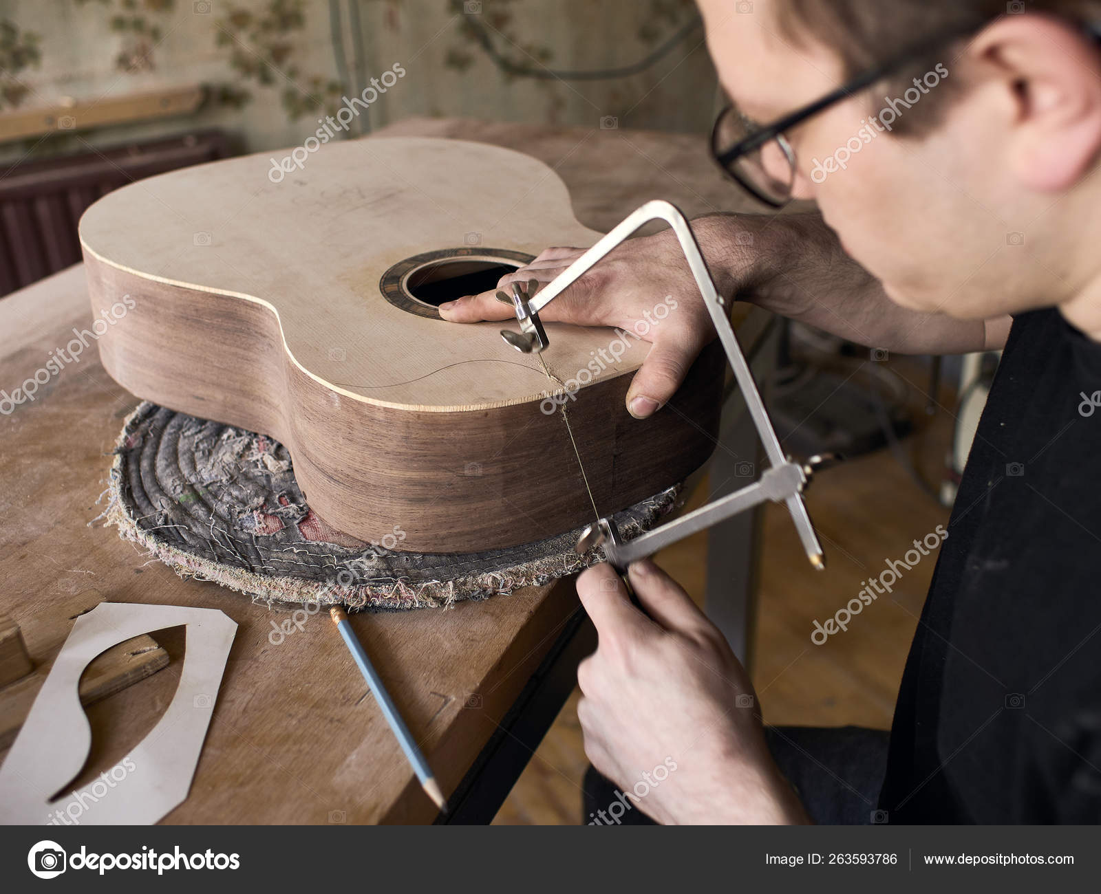 The process of making a cutaway on classical guitar. Stock Photo