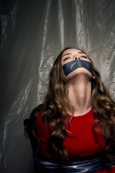 A beautiful girl with a gag in her mouth as a symbol of censorship. — Stock Photo, Image