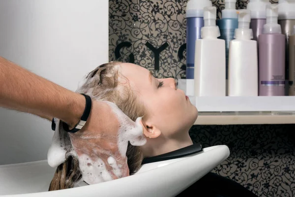 Young woman washing hair in salon Royalty Free Stock Images