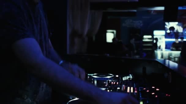 Ο DJ στην κονσόλα συνδυάζει μουσική σε ένα νυχτερινό κλαμπ χορού. — Αρχείο Βίντεο