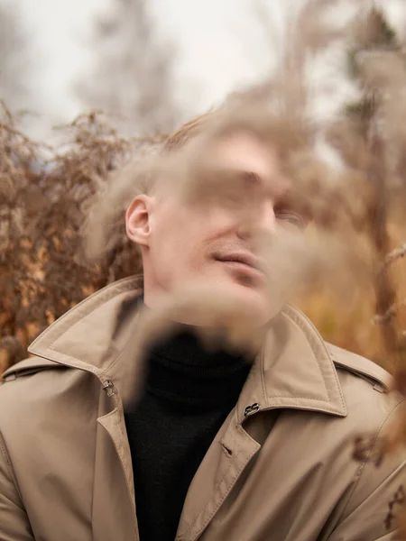 Autumn mood, young guy in a raincoat trench coat underground, street style. — Stockfoto