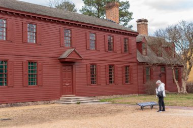 Williamsburg, Va, ABD--9 Ocak 2019. Bir turist colonial Williamsburg, Va Randolph evde dışında bir işareti inceliyor.