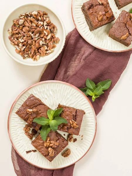 Brownie tatlı çikolata tatlı ceviz ve zanaat plaka üzerinde demek yaprakları ile kopya alanı üzerinde pastel bej arka plan - güzel afiş lezzetli kahverengi Kakaolu pasta pişmiş..