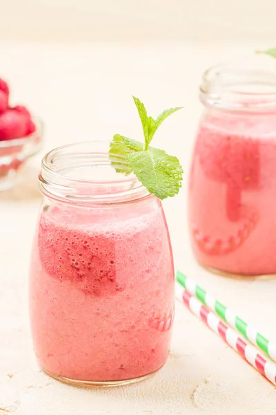 Raspberry smoothie close up photography - fresh blended cocktail with ripe summer berries.