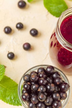 Taze yeşil nane yaprakları ve ham Olgun meyveleri yaz karışımlı vitamini sağlıklı gıda kavramı için kokteyl şeffaf kavanoz sarı pastel arka planda - frenk üzümü güler yüzlü süslenmiş.