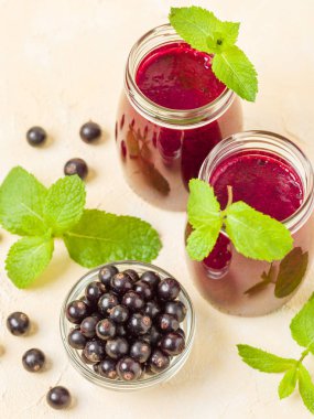 Taze yeşil nane yaprakları ve ham Olgun meyveleri yaz karışımlı vitamini sağlıklı gıda kavramı için kokteyl şeffaf kavanoz sarı pastel arka planda - frenk üzümü güler yüzlü süslenmiş.