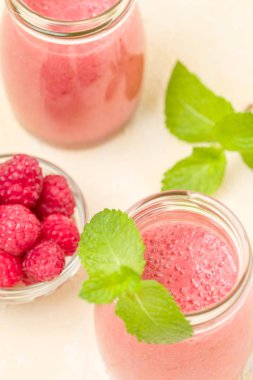 Ahududu güler yüzlü yakın taze yaz fotoğrafla kadar kokteyl ve olgun çilek sağlıklı beslenme ve yaşam tarzı konsepti için pastel sarı zemin üzerine karışık.